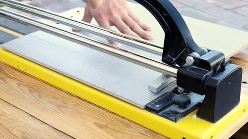 Tile Cutter Used to Slice Gray Tile