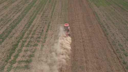 Small Tractor Cultivating Soil at Agricultural Field Aerial View
