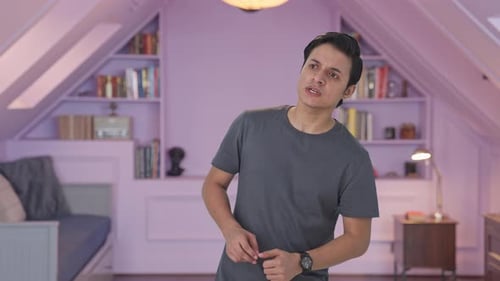 Young Adult Checking Watch Indoors at Home