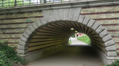 The camera enters a distinct white and red candy cane-striped underpass, a unique feature in New Yor