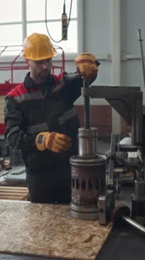 Male Worker Repairing Machine Equipment at Industrial Plant