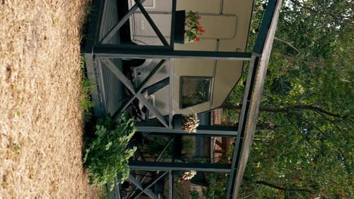 vertical video A mobile home with a terrace is located in country glamping site for relaxation