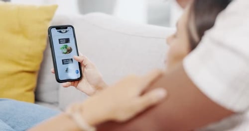 Couple, phone and online shopping on food menu for meal, order or delivery on living room sofa