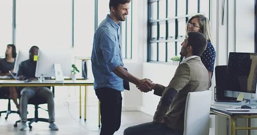 Business Agreement: Smiling Colleagues Shaking Hands in Office