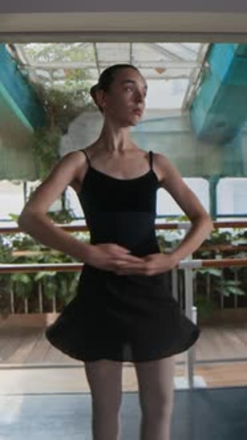 Vertical of Graceful Ballet Dancer Practicing in Studio