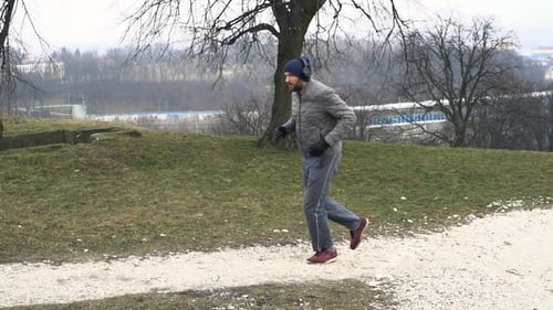 Male Jogger in Headphones Running in City Park, Super 240