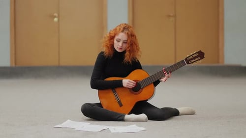 Woman Plays Acoustic Guitar Indoors
