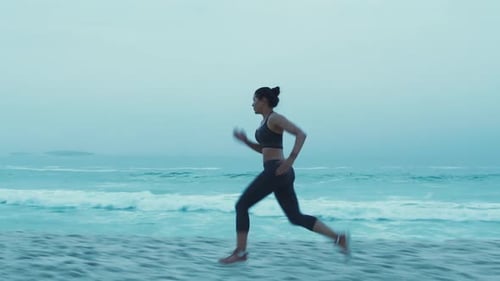 Woman, runner and on beach for training, fitness and workout for health, wellness or cardio