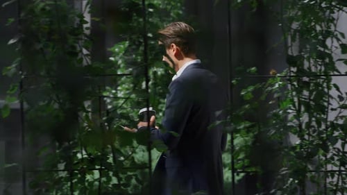 Calm Business Man Going Browsing Digital Tablet in Urban Office Center Outdoors