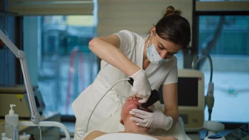 Woman Receiving Facial Treatment at Medical Office