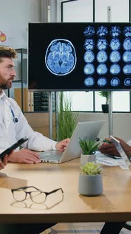 Doctors Discuss Brain Scans in Office Meeting