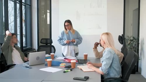Diverse group of young people working on new project together in office.