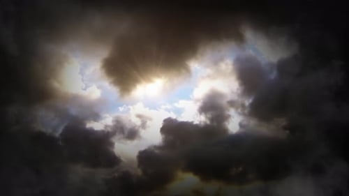 Dark Storm Clouds with Sunlight Breaking Through