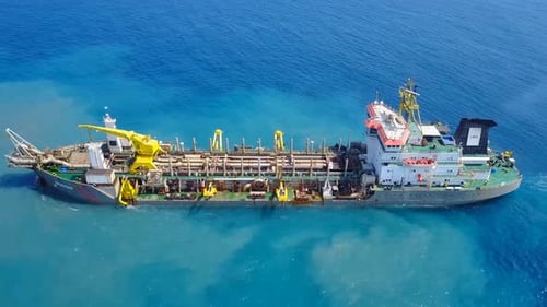 Trailing Suction Hopper-Dredger ship roaring across the sea