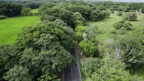 Aerial View of a Car Driving on a Rural Highway Through the Forest - Colombia