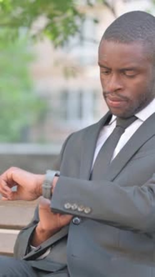 Close up of African Man Using Smartwatch Outdoor, Vertical Video