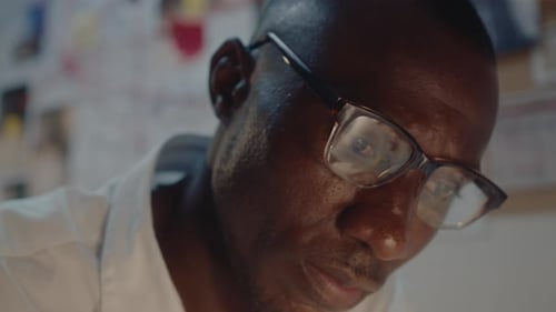 Close-Up of Black Detective Working at Night on Crime Investigation