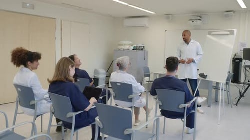 Medical Team Attending Presentation By Doctor in Hospital Conference Room