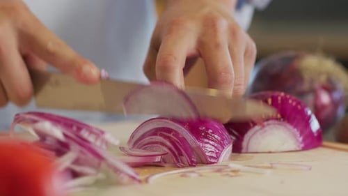 Close Up Shot Of Man Cutting An Onion