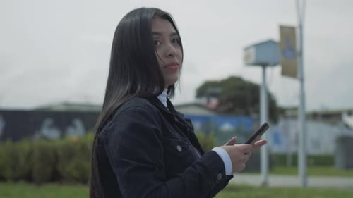 Young Woman Using Smartphone in the City