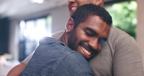 Two Men Smiling and Embracing Tightly