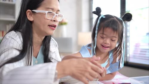 Teacher Helping Children with an Art Project
