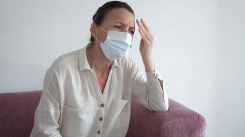 Woman with Mask Experiences Headache and Sore Throat