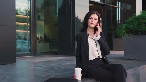 Woman in Business Attire Talking on Phone Outside