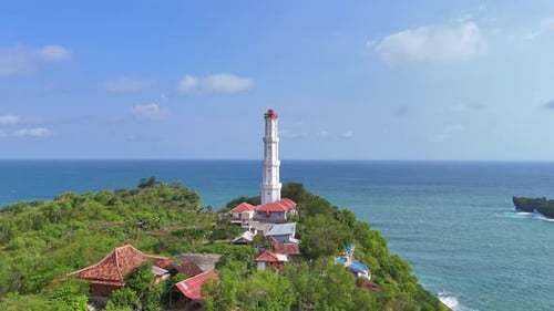 Lighthouse on a Tropical Island Cliff Overlooking the Azure Sea