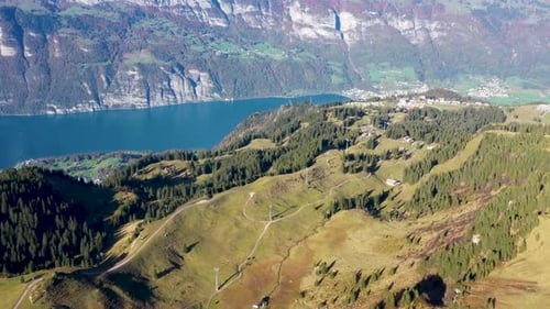 Establishing shot of Walensee Lake with a ski lift operating the in the valley below