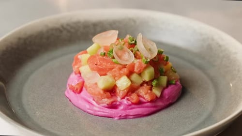 Chilean Salmon Tartar Seviche with Avocado and Cucumber on Purple Cream Cheese with Green Onion on