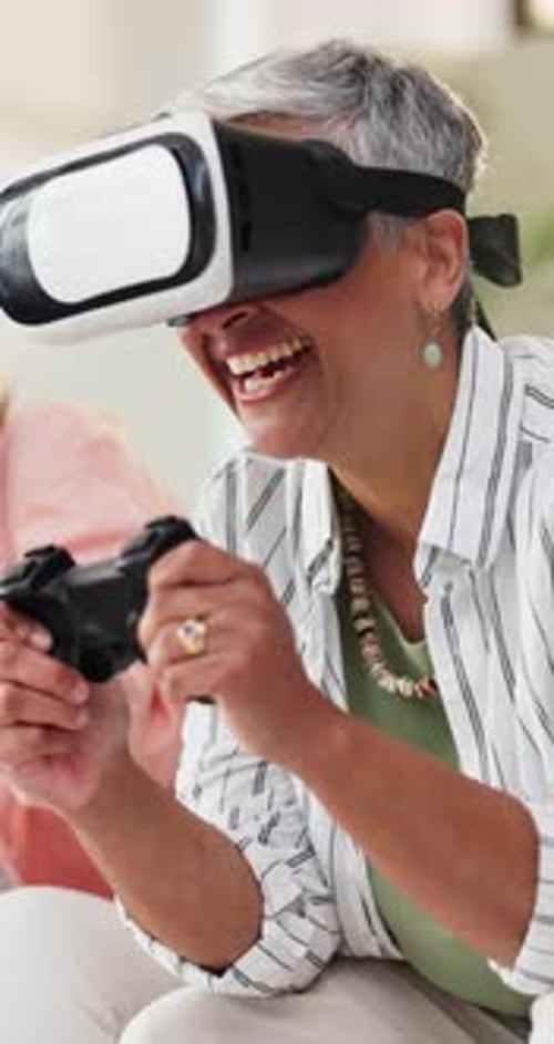 Senior woman using VR headset and video game controller