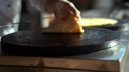 Preparing Savory Crepe on Grill With Gloves