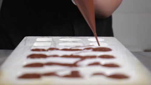Chocolatier Pouring Melted Chocolate Into Molds in Pastry Shop Tempering Chocolate Craft Sweets