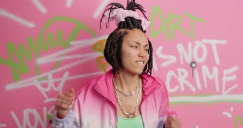 Happy Woman Dancing in Front of Graffiti Wall