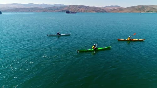 Kayakers Paddling on a Lake Aerial View