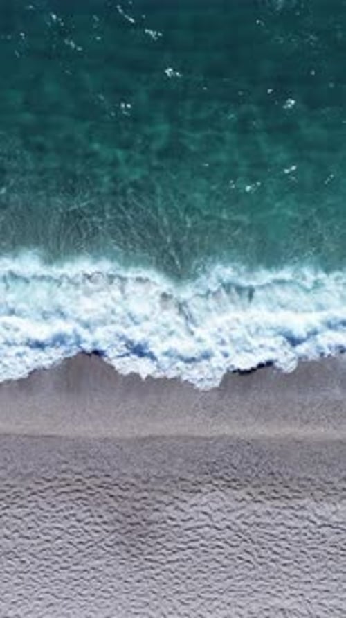 Beach shore breaking waves from above