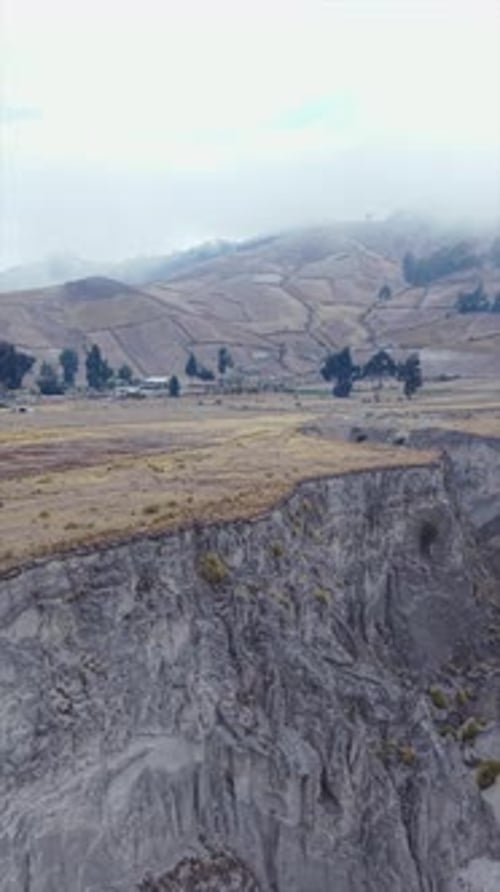 Vertical Aerial Panorama Capturing Verdant Canyon in Ecuadorian Landscape Revealing Farmlands