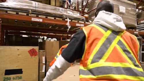 Male Warehouse Workers Lifting Large Cardboard Box Together 3539 Years
