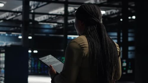 Admin Reviews Power Management with Green Screen Tablet in Data Center