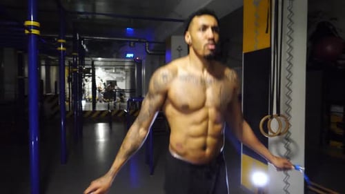 Strong African Athlete with Tattoos Skipping with a Jump Rope at Sport Club Young Black Sporty Man