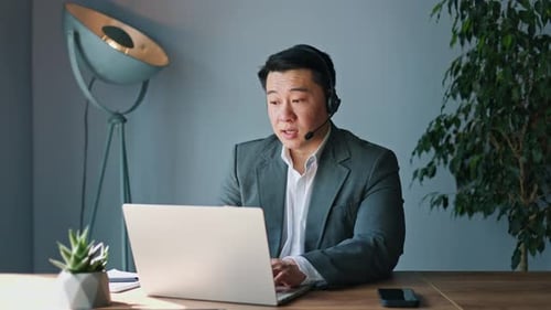 Man Talking at Desk in Home Office