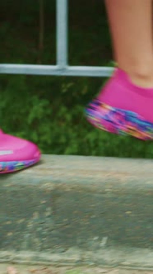 Dynamic Movement Captured Zooming in on a Vibrantly Colored Athletic Shoe MidStride Showcasing the