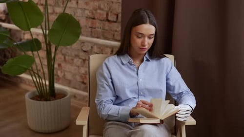 Woman Reading Book with Prosthetic Arm