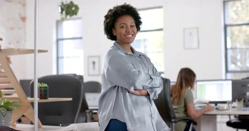 Portrait of happy african american casual businesswoman in office, slow motion
