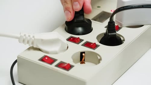 White Power Strip with Many Various of Cords and Cables in Closeup An Extension Cord with Many Power