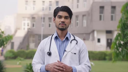Young Doctor in Lab Coat Speaking to Camera