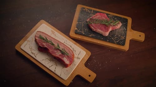 Raw Meat with Rosemary on Cutting Boards