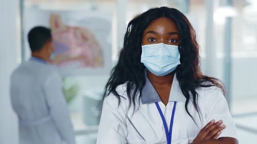 Portrait of Confident Professional Young Doctor Female Afroamerican General Practitioner Crossing