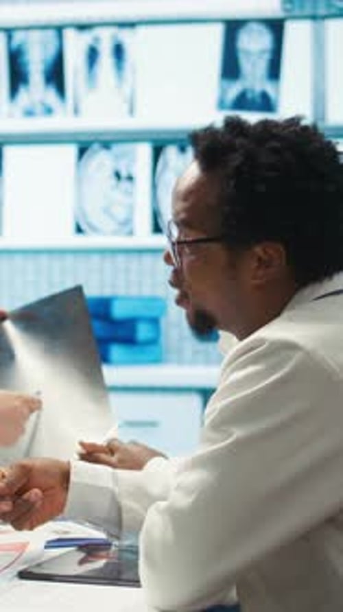 Doctors Reviewing X-Ray in Examination Room